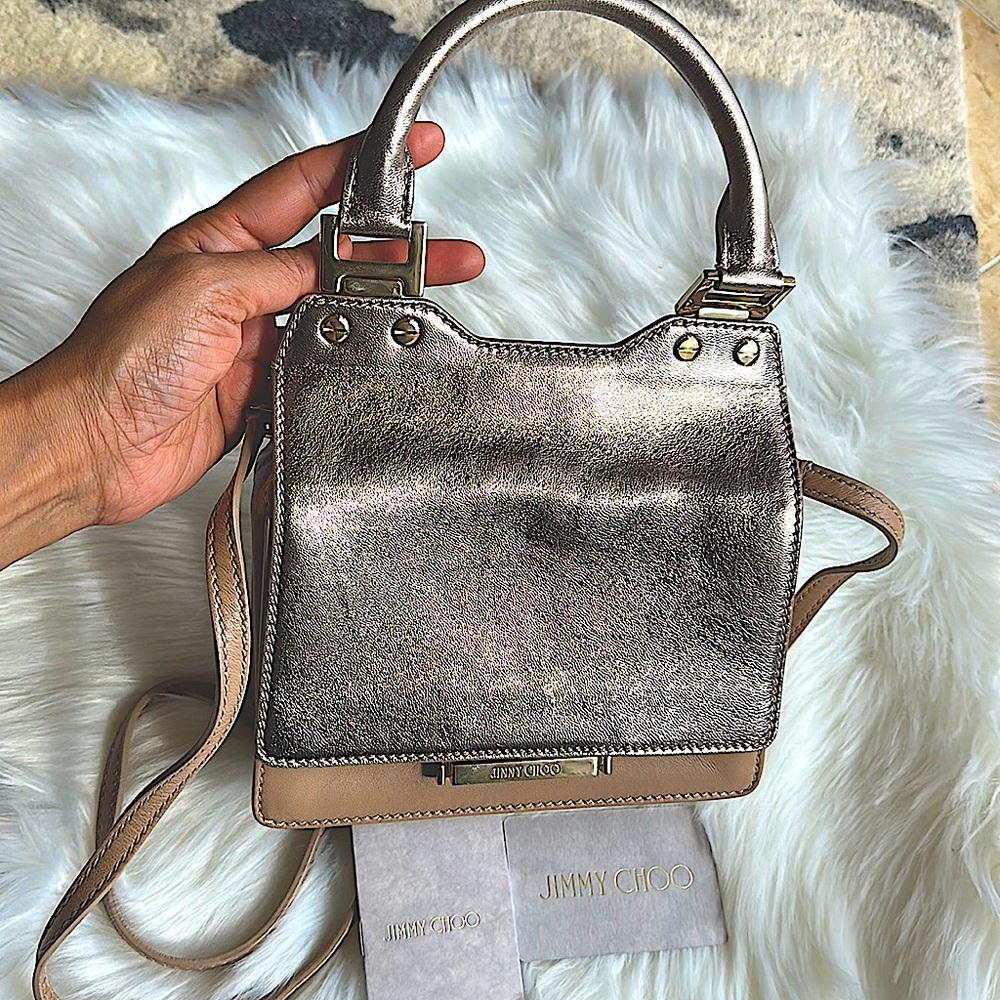 Jimmy Choo bag with handle and crossbody option in beige and rose gold leather.
